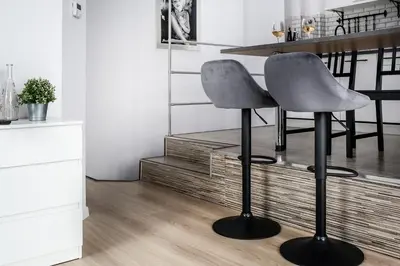 a kitchen with a bar stool and a table at Fully-furnished Apartment with Air Conditioning for families, Cracow Old Town in Kraków