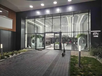a building with a large glass window with a gym at Beautiful Apartment- FREE GARAGE- WIŚLANE TARASY in Kraków