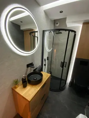 a bathroom with a sink and a shower with a mirror at Beautiful Apartment- FREE GARAGE- WIŚLANE TARASY in Kraków