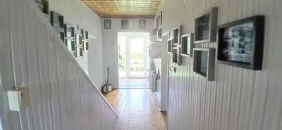 a hallway with pictures on the walls of a house at Królówka in Maków Podhalański