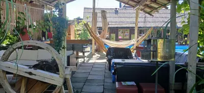 a patio with a hammock and a hammockostructivating at Królówka in Maków Podhalański