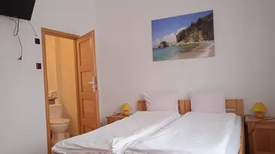 a bedroom with a bed with a picture on the wall at Królówka in Maków Podhalański
