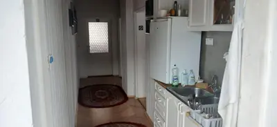 a small kitchen with a sink and a refrigerator at Królówka in Maków Podhalański