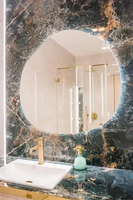 a bathroom with a sink and a mirror at Greendustry Zabłocie Luxury Apartments WAWELOFTS in Kraków