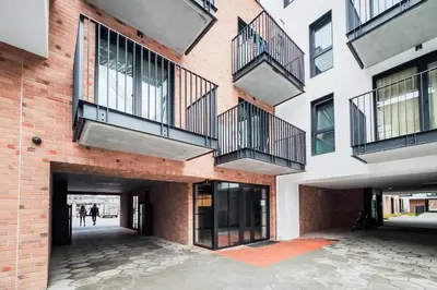 a building with balconies on the side of it at Greendustry Zabłocie Luxury Apartments WAWELOFTS in Kraków