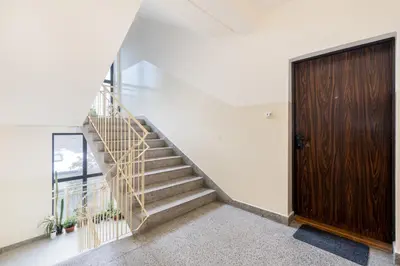 a staircase in a house with a wooden door at Park Białoprądnicki Blue Studio by BookingHost in Kraków
