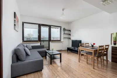 a living room with a couch and a table at Lea Cosy Apartment by BookingHost in Kraków