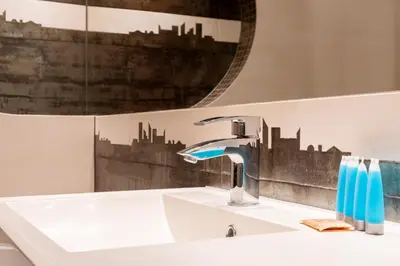 a bathroom with a sink and a mirror at Lea Cosy Apartment by BookingHost in Kraków