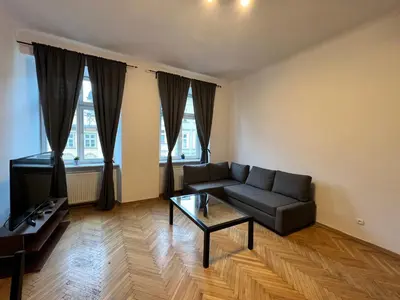 a living room with a couch and a coffee table at Apartament rodzinny 14 in Kraków