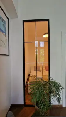a living room with a mirror and a couch at Center High Apartment CityBeat#1 in Kraków