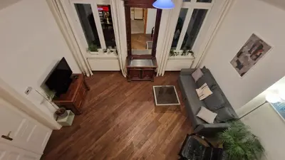 a living room with a couch and a television at Center High Apartment CityBeat#1 in Kraków