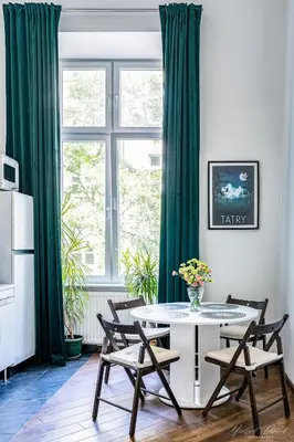 a dining room with a table and chairs and a window at Center High Apartment CityBeat#1 in Kraków