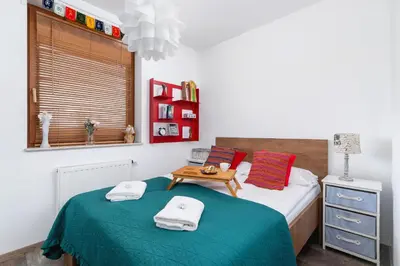 a bedroom with a bed with a table on it at Apartments Cracow Czeczow by Noclegi Renters in Kraków