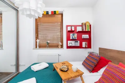 a living room with a table and a couch at Apartments Cracow Czeczow by Noclegi Renters in Kraków