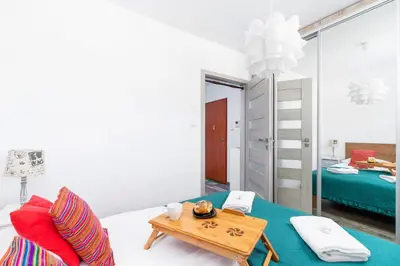 a room with a bed and a table at Apartments Cracow Czeczow by Noclegi Renters in Kraków