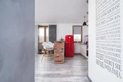 a kitchen with a red refrigerator and a table at Apartments Cracow Czeczow by Noclegi Renters in Kraków