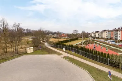 an empty road in a city with a fence at Apartments Cracow Czeczow by Noclegi Renters in Kraków