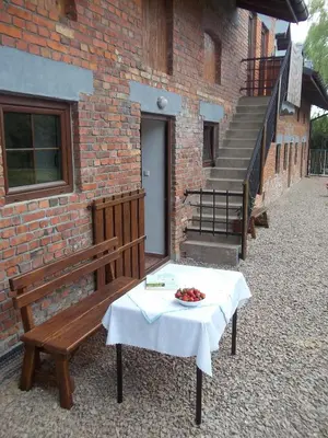 a table and a bench with a bowl of fruit on it at Dwór w Boleniu in Bolen