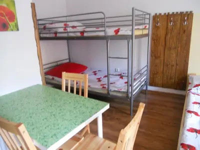a room with a table and a bunk bed at Dwór w Boleniu in Bolen