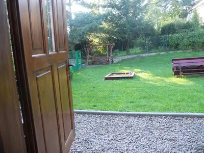 an open door to a yard with a playground at Dwór w Boleniu in Bolen