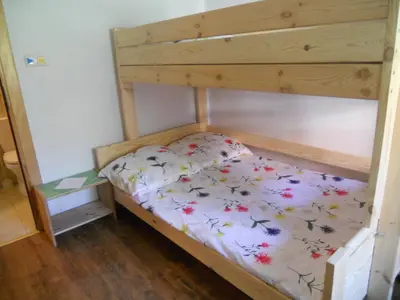 a bunk bed with a bedsheet with flowers on it at Dwór w Boleniu in Bolen