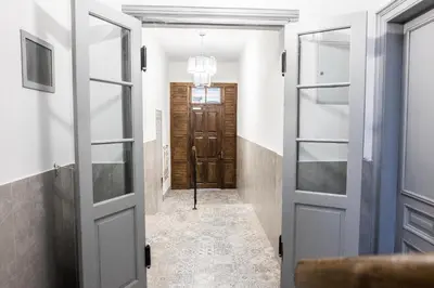 a hallway with a door leading to a room at CracWoW K8 No.6 Apartment in Kraków