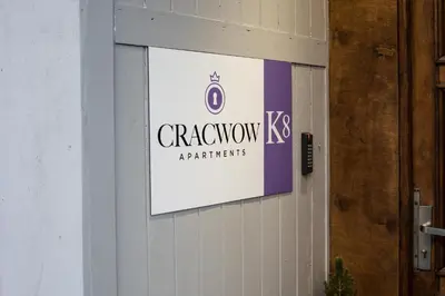a sign on the side of a building at CracWoW K8 No.6 Apartment in Kraków