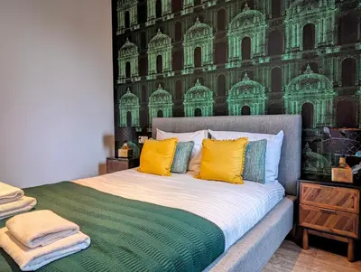 a bedroom with a bed with yellow and green pillows at Stachowicza 5 by Homeprime in Kraków