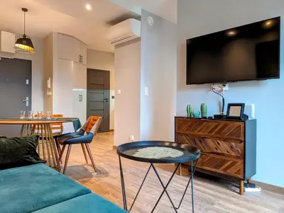 a living room with a couch and a tv on a wall at Stachowicza 5 by Homeprime in Kraków