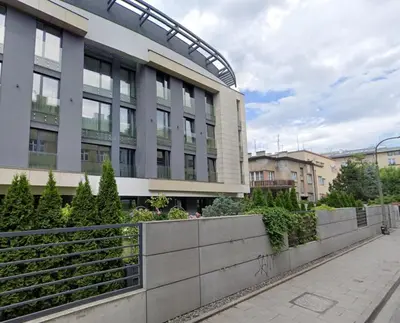 a building with a fence in front of it at Stachowicza 5 by Homeprime in Kraków