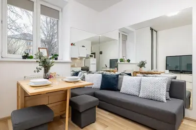 a living room with a couch and a table at Pet-Friendly & Cozy Studio in Kraków by Noclegi Renters in Kraków