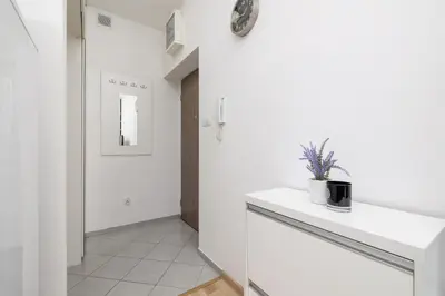 a kitchen with white walls and a white counter at Pet-Friendly & Cozy Studio in Kraków by Noclegi Renters in Kraków