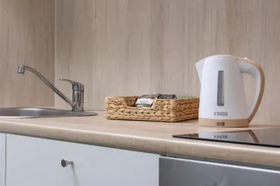a kitchen counter with a kettle and a basket on it at Pet-Friendly & Cozy Studio in Kraków by Noclegi Renters in Kraków