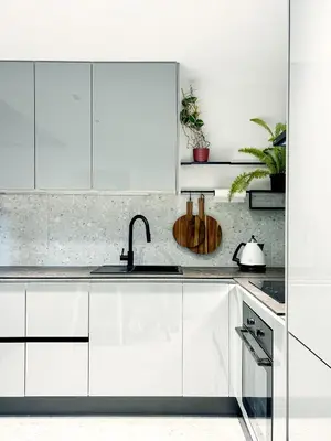 a kitchen with white cabinets and a sink at Composition No. 2 in Kraków