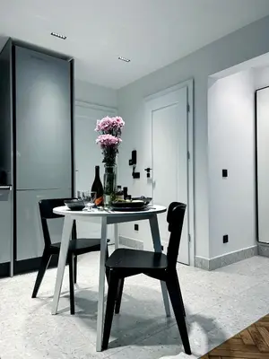 a dining room with a table and chairs and flowers at Composition No. 2 in Kraków