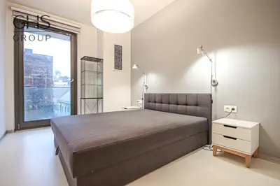 a bedroom with a large bed and a large window at Ekskluzywny Apartament obok Zamku Wawelskiego in Kraków