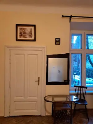 a room with a white door and a glass table at Apartment St. Mark's Square in Kraków