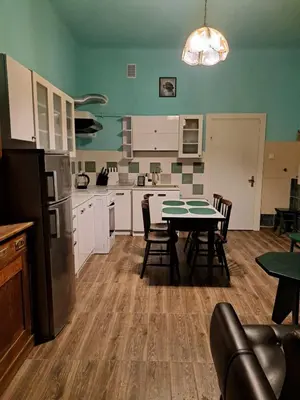a kitchen with a table and chairs in a room at Apartment St. Mark's Square in Kraków