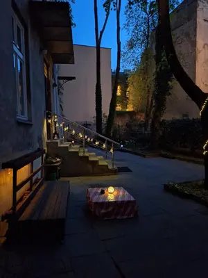 a group of lights on a porch with a bench at Apartment St. Mark's Square in Kraków