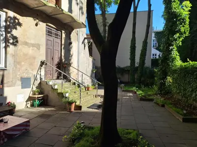 a house with a door and a tree in a yard at Apartment St. Mark's Square in Kraków
