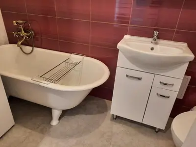 a bathroom with a sink and a tub and a toilet at Apartment St. Mark's Square in Kraków