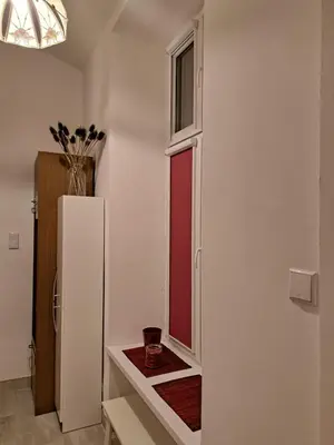 a kitchen with a white refrigerator and a window at Apartment St. Mark's Square in Kraków