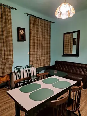 a room with a table and chairs and a couch at Apartment St. Mark's Square in Kraków