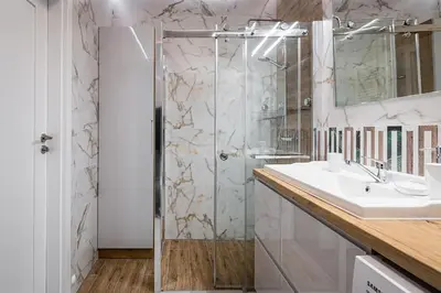 a bathroom with a shower and a sink at Golden residence apartment in Kraków