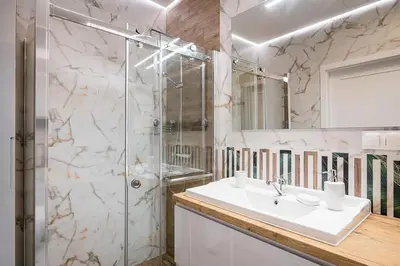 a bathroom with a sink and a shower at Golden residence apartment in Kraków