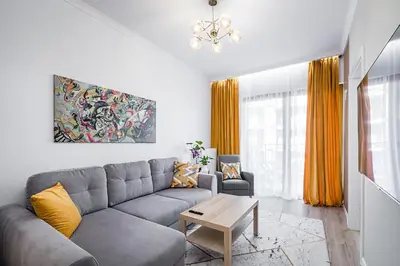 a living room with a couch and a table at Golden residence apartment in Kraków
