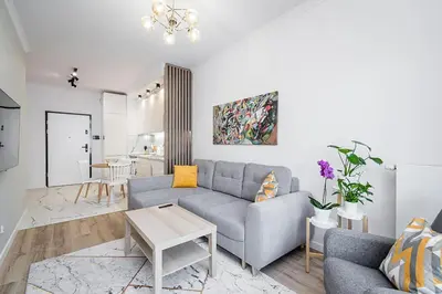 a living room with a couch and a table at Golden residence apartment in Kraków