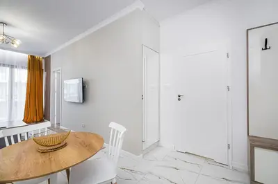 a white room with a wooden table and chairs at Golden residence apartment in Kraków
