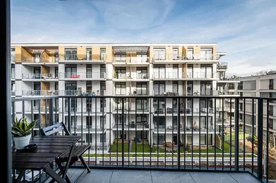 a large apartment building with a table and a balcony at Golden residence apartment in Kraków