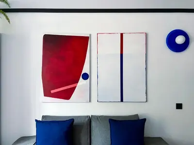 a living room with two blue pillows and a couch at Composition 23 with blue circle in Kraków